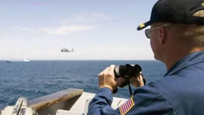 This photo, supplied by th US Navy, shows the commanding officer of a US Navy guided-missile cruiser monitors the pirated Ukrainian cargo ship Faina off the coast of Somalia.