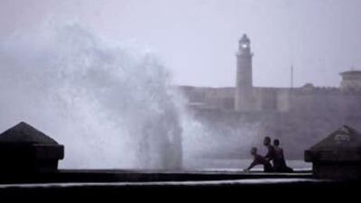 Locals look at waves battering the Malecon waterfront in Havana, before the arrival of Hurricane Ike.