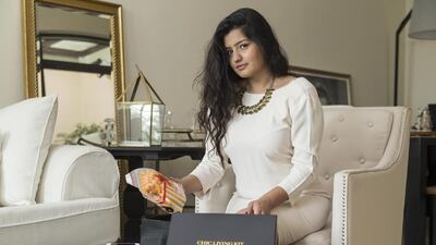 Nicola Monteath packs one of her specially curated Chic Living Kit subscription boxes at her home in Dubai. Antonie Robertson / The National