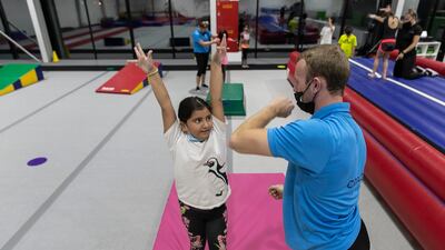Children take part in an after-school gymnastics class.