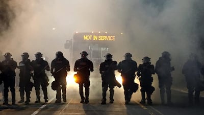 Police officers wearing riot gear block a road during protests after police fatally shot Keith Lamont Scott in the parking lot of an apartment complex in Charlotte, North Carolina in the US on September 20, 2016. Adam Rhew/Charlotte Magazine/Reuters
