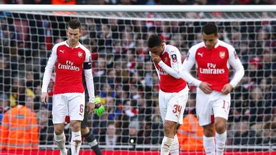 Arsenal players Laurent Koscielny, left, Francis Coquelin and Alexis Sanchez react after Burnley's 1-1 equaliser on Saturday. Eddie Keogh / Reuters