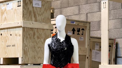 Martin Margiela, 'Artisanal' spring / summer 2001: Backless top made from assembled vintage black gloves, with a pleated red skirt made of assembled vintage skirts. Photo: Sotheby's