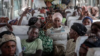Displaced people who fled Goma on a bus in Sake. They are seen with their belongings, waiting to be taken home. All photos by AFP