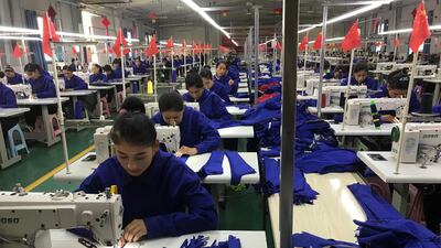 Factory workers in Hotan prefecture. The majority of graduates from Moyu vocational centre find jobs in factories.