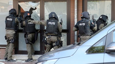 Police officers raid the rooms of a mosque in Hildeshein, Germany, on July 27, 2016. Chris Gossmann / EPA