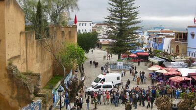 Townsfolk gather as police herald a murder suspect to different cafes during a murder reenactment. Photo by Samar Al Sayed