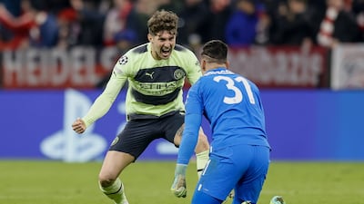 Manchester City goalkeeper Ederson celebrates Erling Haaland's goal with teammate John Stones. EPA