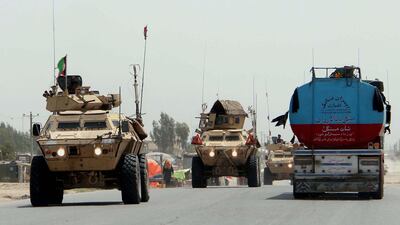 Afghan security officials patrol on highway in Helmand, Afghanistan, April 29, 2020. Although clashes between the Afghan security forces and the Taliban fighters continued in rural areas, attacks in cities had come down to almost nil. EPA