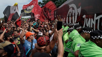 Flamengo supporters alongside the team bus at the international airport in Rio de Janeiro. AP