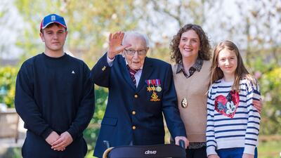Then 99-year-old British veteran Captain Tom Moore with grandson Benji (L), daughter Hannah Ingram-Moore (2-R) and granddaughter Georgia (R) outside his home after completing the 100th length of his back garden. EPA