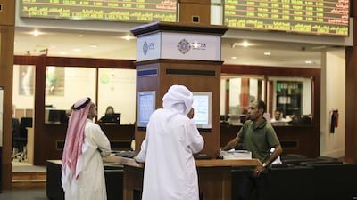 Traders work on the floor at the Dubai Financial Market. UAE stock markers are set for a tricker year according to experts after bumper gains during 2013. Sarah Dea / The National