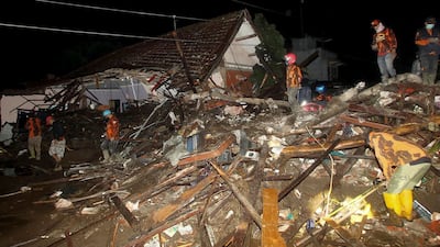 Rescuers search for survivors amidst debris following a flash flood in which 11 people have so far been reported missing, in Malang, East Java on November 4, 2021. (Photo by Str / AFP)