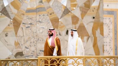 Sheikh Mohamed bin Zayed and Prince Mohamed bin Salman stand for the national anthem during an state visit at Qasr Al Watan.