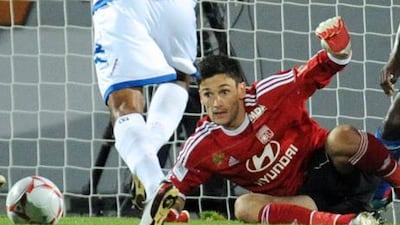 French goalkeeper Hugo Lloris gets low to block a shot from Evian's Aldo Angoula.