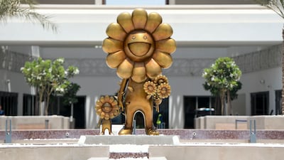 'Flower Parent and Child', a golden sculpture created by Takashi Murakami on the Yas Bay Waterfront promenade, Abu Dhabi. Khushnum Bhandari / The National