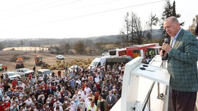 Recep Tayyip Erdogan addresses locals as he visits the wildfire disaster zones Manavgat and Marmaris. At least six people have been killed as around 100 blazes swept through southern and western Turkey.