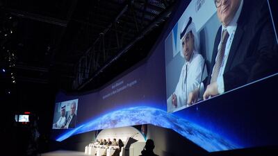 Omran Sharaf, left, and Dr Mike Mcgrath are seen on screen during a panel discussion on Mars Missions: Approaches to Mars Exploration Programmes at Adnec in Abu Dhabi on Wednesday. Delores Johnson / The National