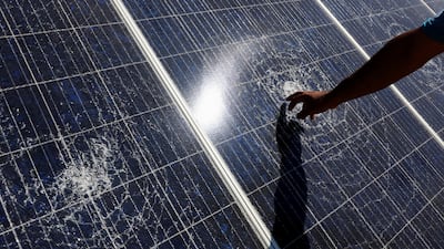 A person points at damage to a solar panel, which Palestinians say was damaged by Israeli settlers, in Tuba in Masafer Yatta, in the Israeli-occupied West Bank. Reuters