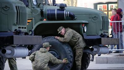 Russian soldiers clean their vehicle before the rehearsal. AP