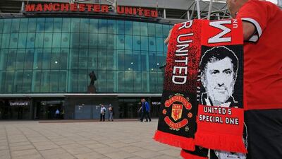 Scarves featuring the image of Manchester United's new Portuguese manager Jose Mourinho are displayed for sale outside the club's Old Trafford football stadium in Manchester. Clint Hughes / AFP