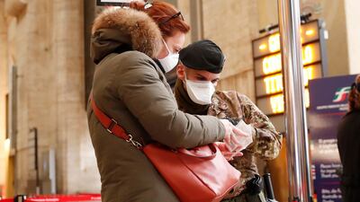 A soldier checks passengers leaving from Milan main train station, Italy, Monday, March 9, 2020. AP Photo