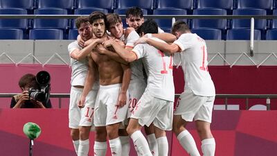 Marco Asensio is mobbed by Spain teammates after his late winning goal against Japan in the Olympics semi-finals.