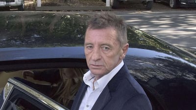 AC/DC drummer Phil Rudd leaves the District Court after being sentenced to eight months home detention in Tauranga, AFP