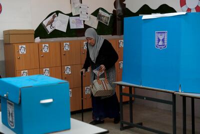An Israeli Arab elderly citizen from Taiybe town casts her ballot at a polling station. EPA