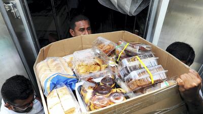 Leftover food from hotels and restaurants is delivered to the UAE Food Bank in Al Quoz on Wednesday. Pawan Singh / The National