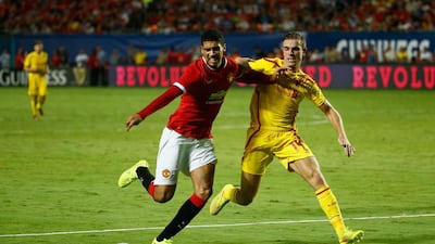 Chris Smalling, left, of Manchester United is challenged by Jordan Henderson of Liverpool in the Guinness International Champions Cup 2014 Final at Sun Life Stadium on August 4, 2014 in Miami Gardens, Florida. Chris Trotman/Getty Images