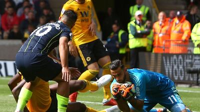 Wolverhampton Wanderers' Portuguese goalkeeper Rui Patricio, right, saves the ball in front of Aguero. AFP