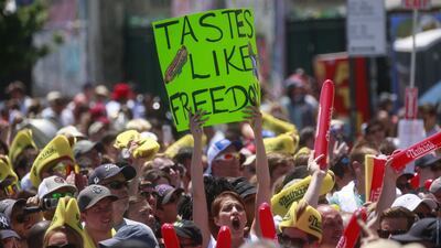 An audience member holds a 'Tastes Like Freedom' sign. AFP