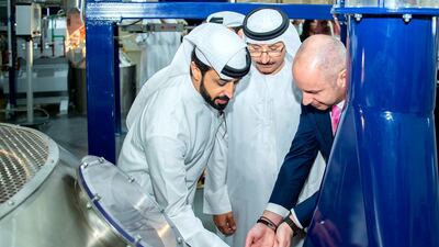 Ahmed Bin Sulayem, executive chairman of the DMCC free zone, watches as coffee beans are processed during the official launch in February 2019. Courtesy: DMCC