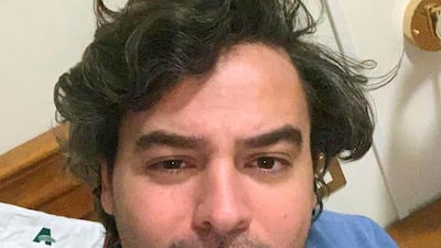 Andrea Napoli, 33, takes a selfie in a hotel being used for patients recovering from coronavirus, in Rome. AP