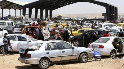 Thousands of families fleeing from Mosul, one of the great historic cities of the Middle East, arrive at a checkpoint in outskirts of Arbil on June 10, 2014. Reuters