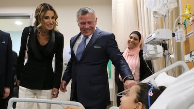 King Abdullah and Queen Rania visit a young patient as they mark the expansion of the King Hussein Cancer Centre in Amman. AFP