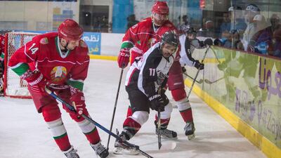 Mobarak Al Mazrouei, No 11, of the Abu Dhabi Storms caught between Ponomarev Stepan, No 14, and Hiebau Andrei, No 16, of Belarus during the President's Cup at the Zayed Sport City Ice Rink. Leslie Pableo for The National