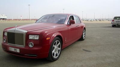 Adel Al Marzouqi waits for his camel Amira at the Al Wathba finish line in his Phantom Rolls-Royce. Anna Zacharias / The National / March 2014.