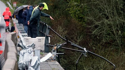 Emergency services were alerted by a motorist who saw a broken railing on the bridge as he drove in heavy rain. AP