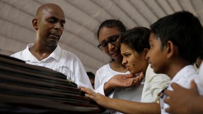 People react near a casket during a mass for victims. Reuters