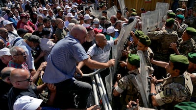 Soldiers scuffle with retired army members outside the Beirut parliament building. AP