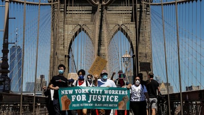 Current and former New York City Mayor's staff march across the Brooklyn Bridge. REUTERS