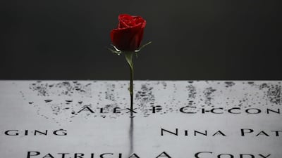 A flower stands along the north pool at the National September 11 Memorial in New York City. AFP