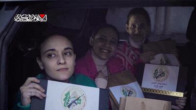 Liberated Israeli hostages from left, Emily Damari, Romi Gonen and Doron Steinbrecher with bags bearing the logo of the armed wing of Hamas. AFP