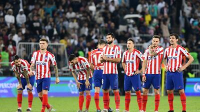 Atletico Madrid players look dejected during the penalty shootout before Real Madrid win the Super Cup. Reuters