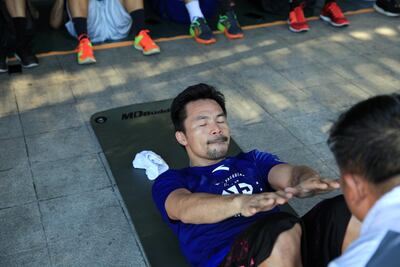 Back in his driveway, Manny Pacquiao and his team hit the mats for abdominal work. His wife, Jinkee, was present, too. Jake Verzosa for The National