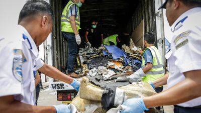 The wreckage is loaded on to lorries.