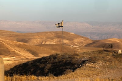 An Israeli flag flutters near Khan Al Ahmar in the Israeli-occupied West Bank on May 20, 2026. AFP
