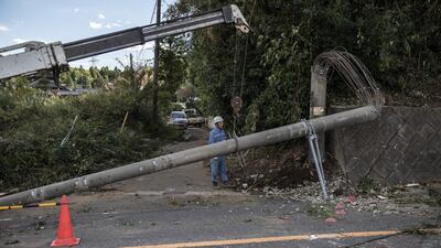 A utility company worker removes an electricity pole in Chiba, Japan. Getty Images